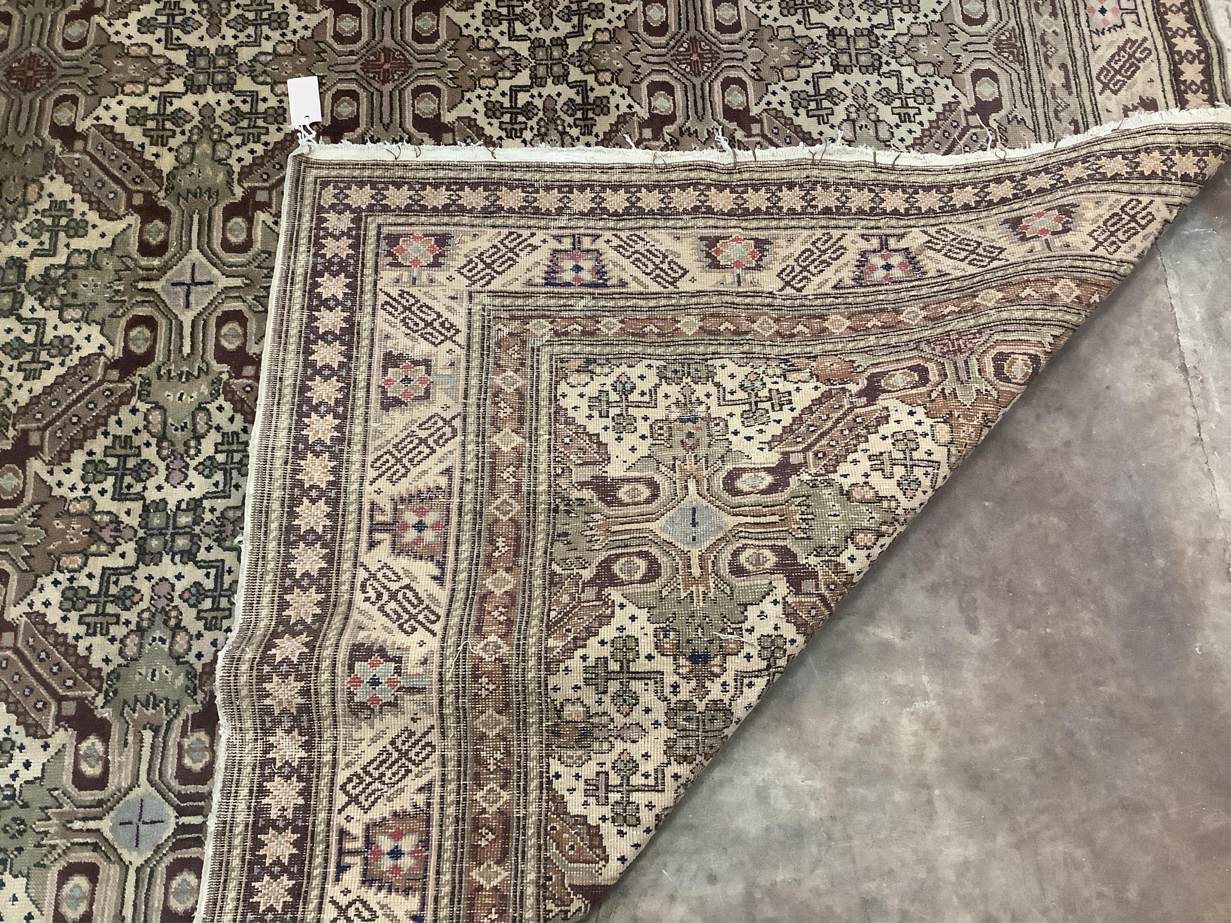 An ivory ground geometric carpet, approx. 290 x 200cm. Condition - fair